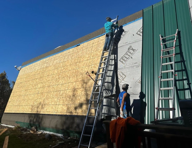 new siding job being done by roofing contractors to show roofing and siding contractors near you